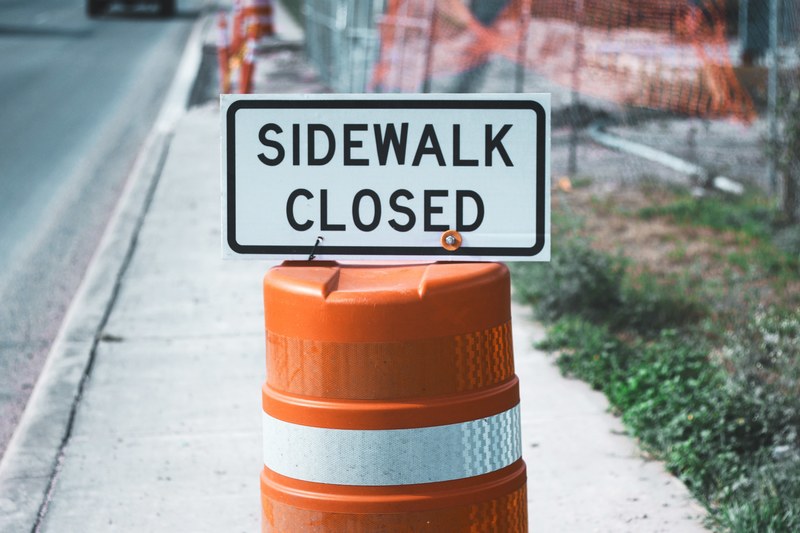 a sidewalk closed sign on an orange traffic cone, sidewalk closed_ 4k