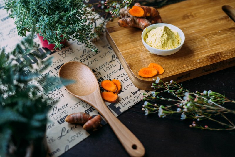 herbs turmeric and spice on cutting board near wooden spoon and paper reading love, herbs and spice on board 4k