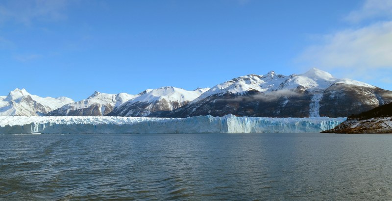 snow capped mountains and a blue glacier at the shore of a lake, lake by a blue glacier 4k