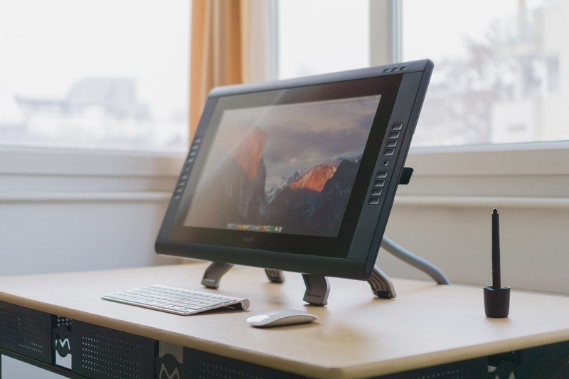 a wacom drawing tablet with a touchscreen on a desk, wacom cintiq 22hd workspace 4k