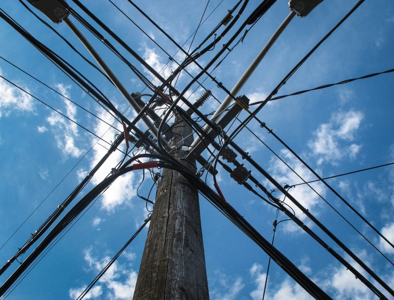 industrial power lines and electrical wires form a grid against a blue sky, cable geometry and blue sky 4k