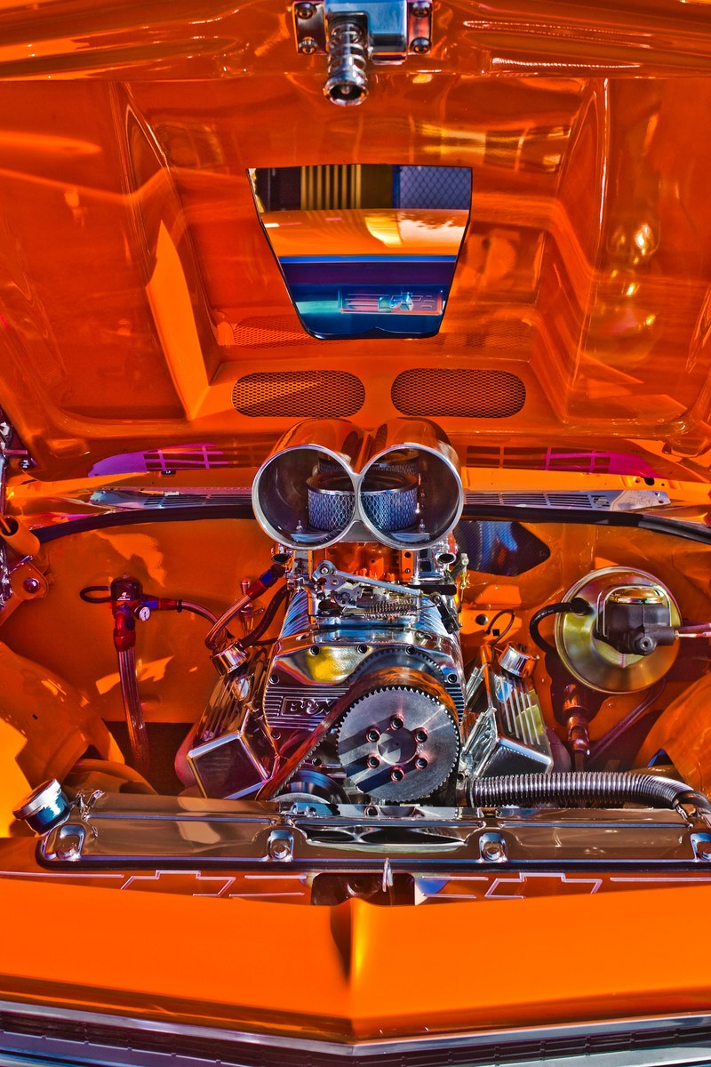 under the hood of an orange car with a shiny metallic engine, vintage car engine 4k