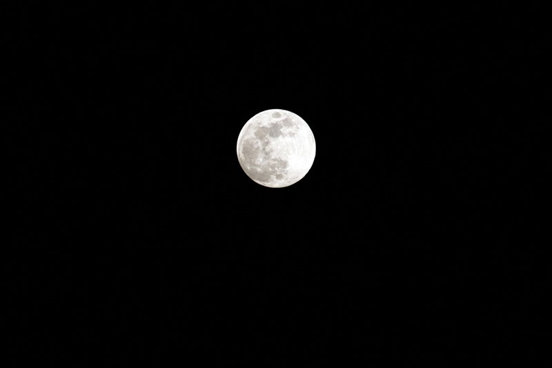 the full moon is seen against the dark night sky, the moons light 4k