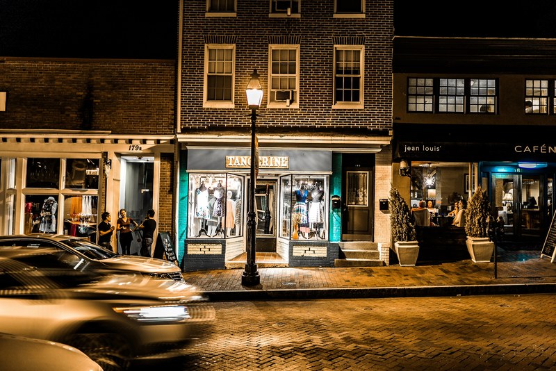 young people talking near storefronts in annapolis at night, storefronts at night 4k