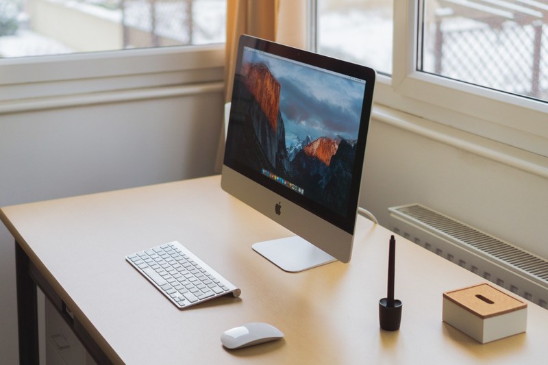 a clean computer workspace with an imac in the corner of a room, winter workspace 4k
