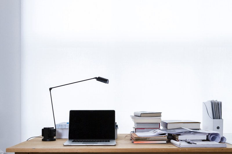 laptop and lamp on desk with stacks of books and files, laptop on desk book stacks 4k