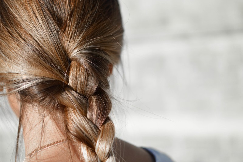 back of a womans head with a casual braid, braided hair 4k
