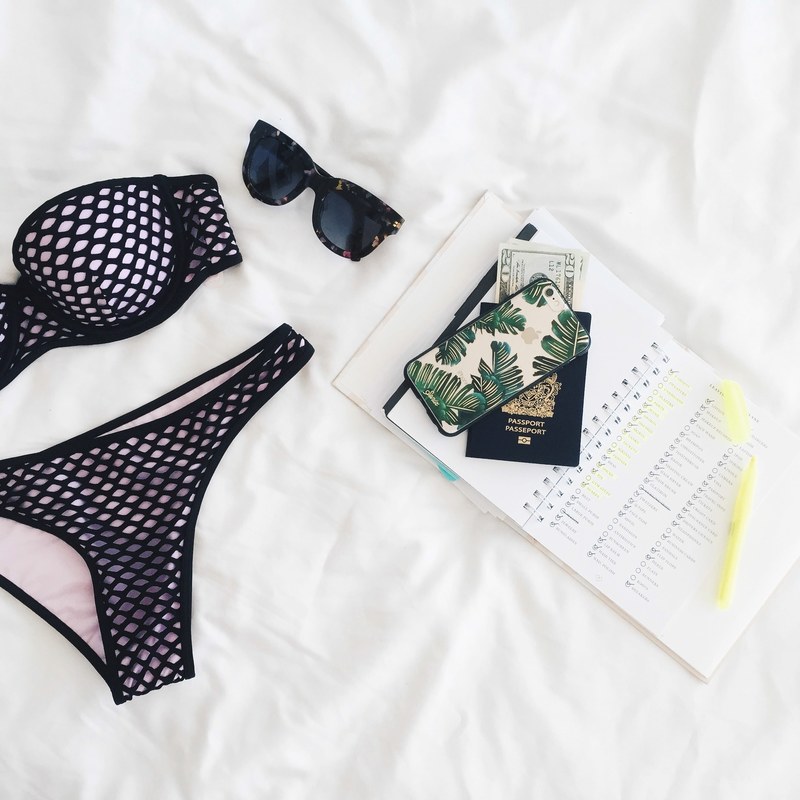 a flatlay with a notebook a phone a passport sunglasses and a bikini, vacation mode 4k