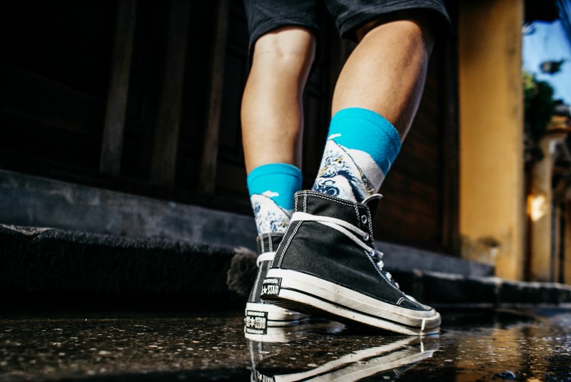a behind the feet shot of a man wearing black and white lace shoes in hi an, footwear fashion shot 4k