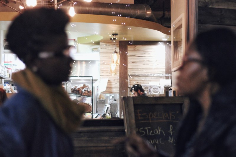 two african american people standing in front of each other in a cafe, _with my tribe 4k