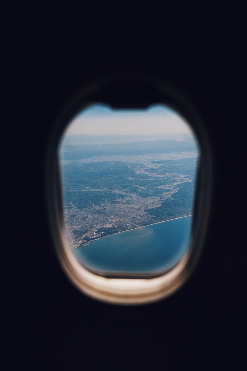 view of a coastline from the window of an airplane, _air plane window 4k