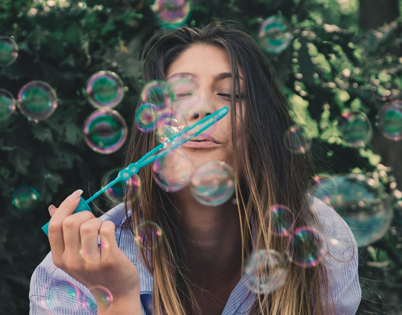 happy woman blowing bubbles outside, bubble of happiness_ 4k