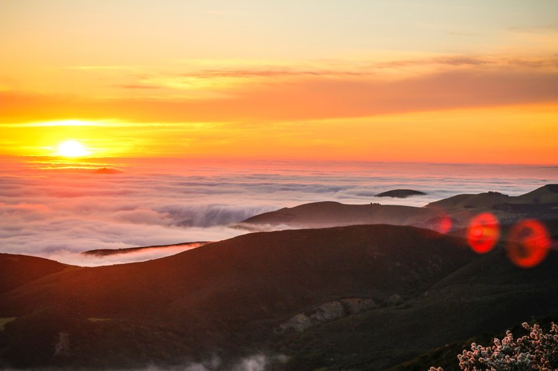 a sunset over the clouds and valleys looking out from cuesta ridge botanical interest area, sunset over the clouds 4k