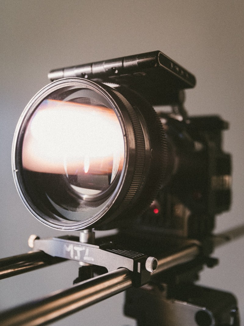 close up of a video camera lens reflecting bright light, lens flare 4k