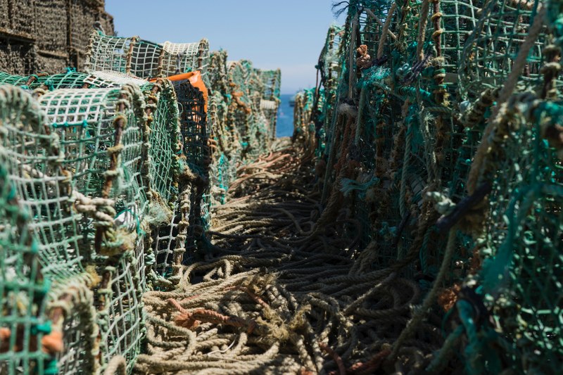 crab and lobster traps stacked on top of one another with rope tied to them in cascais, waiting a fisherman to catch lobsters and crab 4k