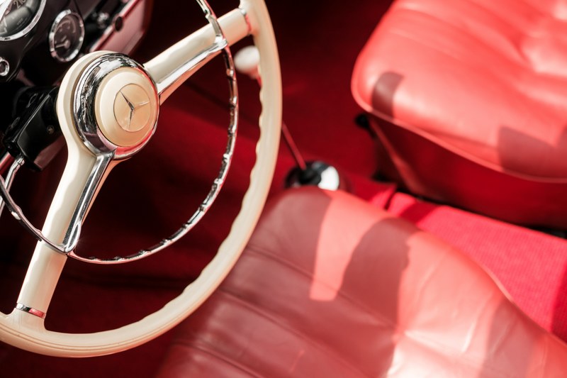 a white steering wheel in a car with red interior, _white steering wheel 4k