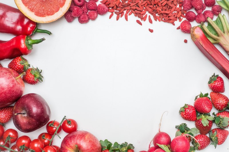 red fruit and vegetable border with berries chilis and seeds on a white table, red fruit and vegetables hero image 4k