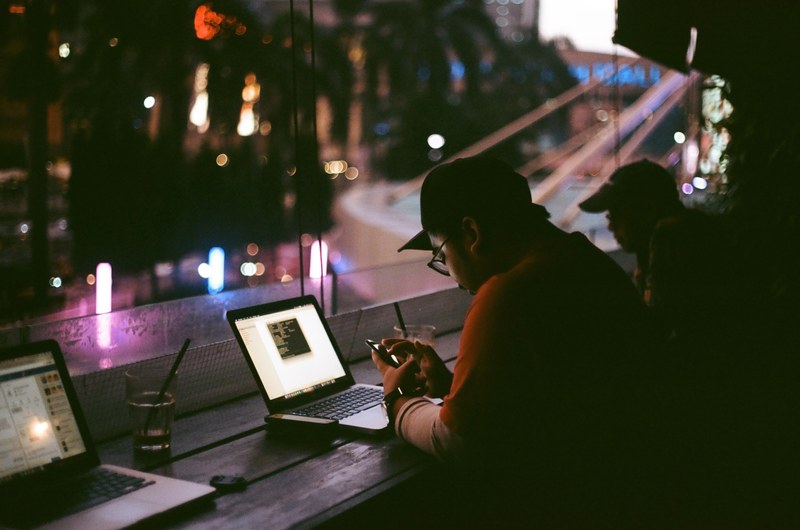 people working late by the windows of a cafe at night, working late 4k