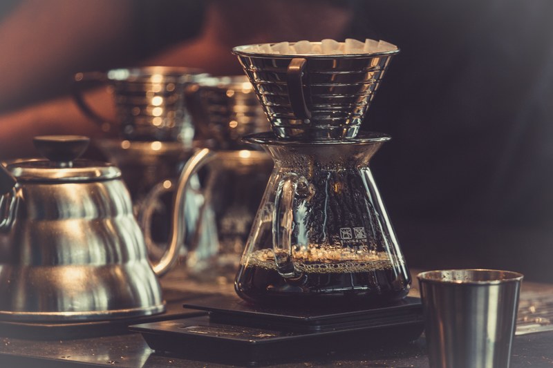 a jar with drip brewed coffee on a counter, drip brewing 4k