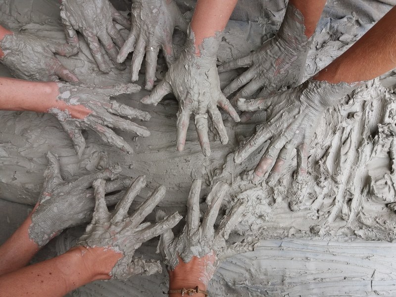 hands dirty with mud playing in gray clay, hands 4k