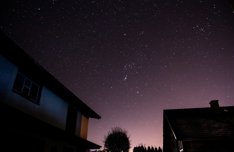 houses and trees silhouetted against a purple starry night sky, purple starry sky 4k