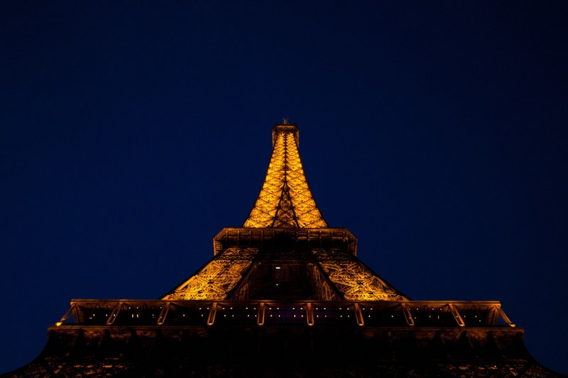 looking up at the eiffel tower illuminated at night in paris, looking up at lit eiffel tower 4k