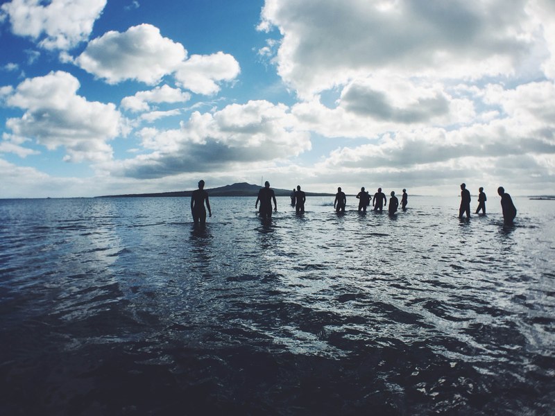 group of people in the waist deep ocean at narrow neck beach, narrow neck beach 4k