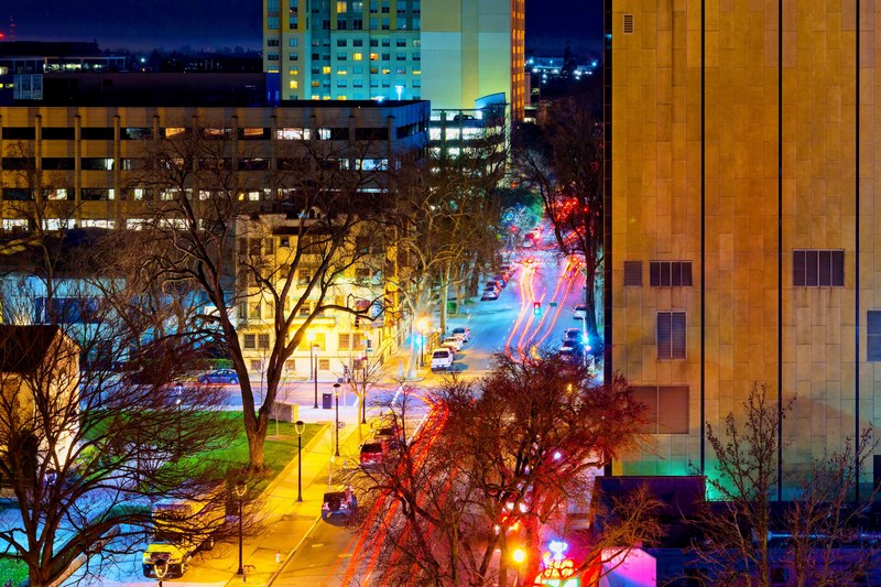 a rich and colorful shot of a busy street in midtown taken early in the night, street lights on a busy night in midtown 4k