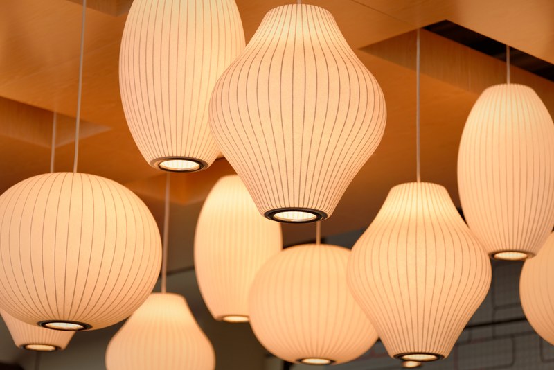 multiple lanterns hanging from an orange ceiling, paper lampshades 4k