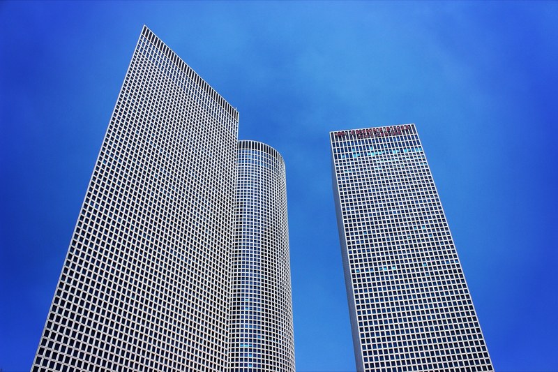 shot of skyscraper towers with windows from below with clear blue sky, skyscraper windows with sky 4k