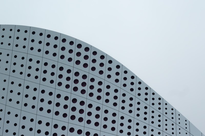 a dotted pattern on a white curved facade, dots on a modern facade 4k
