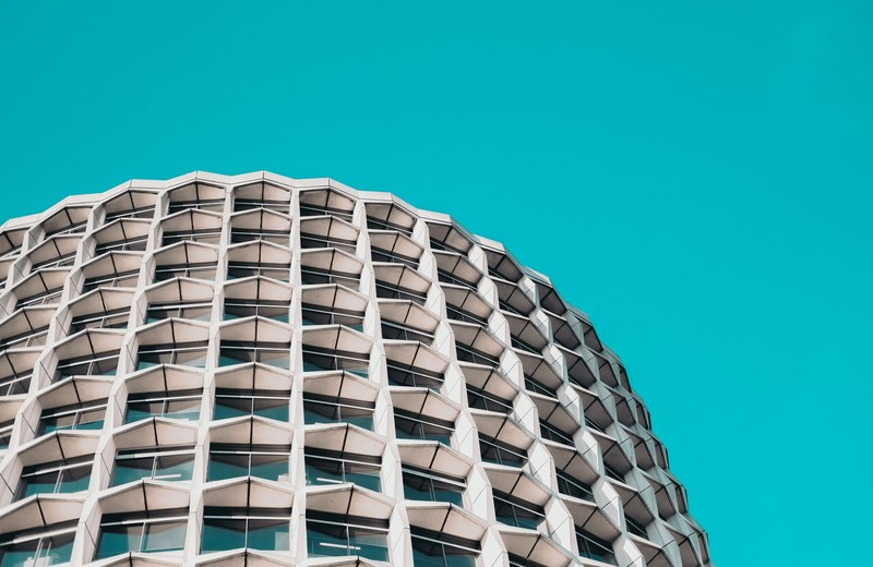 cruciform concrete blocks on the facade of a round building, modern living 4k