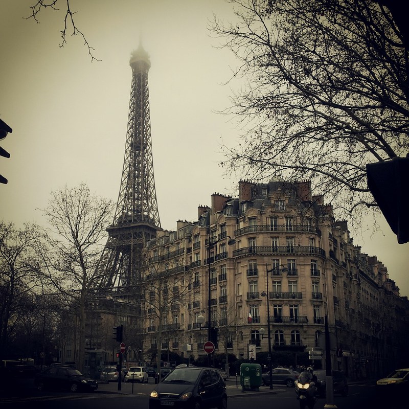 a sepia toned cloudy view of the eiffel tower in paris from the street, sepia eiffel tower 4k