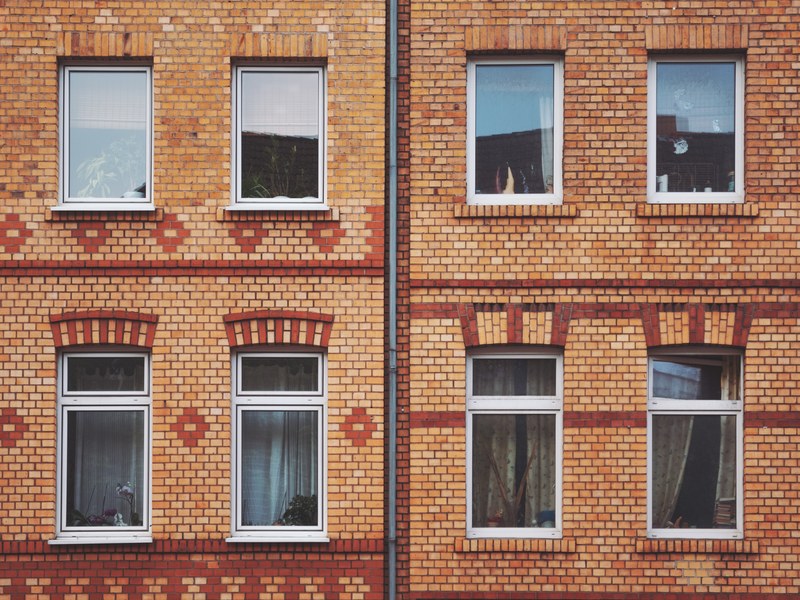 modern orange brick apartment complex with white window panes and reflective glass, orange brick apartment 4k