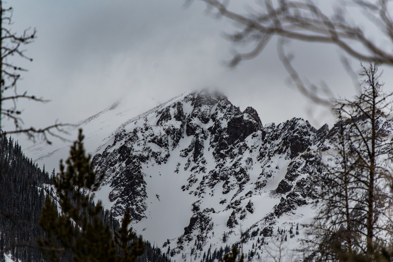 a snow covered mountain with its peak enveloped in clouds, red mountain in clouds 4k