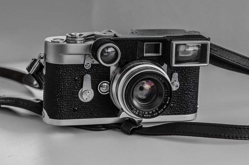 vintage camera with leather black strap on a white surface, camera reflex camera vintage camera and photography 4k
