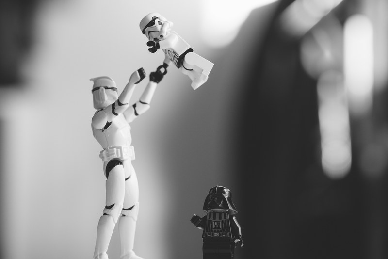 black and white shot of toy star wars storm trooper and darth vader from star wars figures in motion, monochrome star wars toys 4k