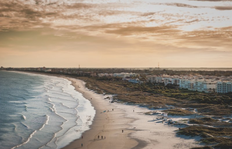 ocean waves washing on the sandy shoreline near the town at port canaveral, sandy shoreline 4k