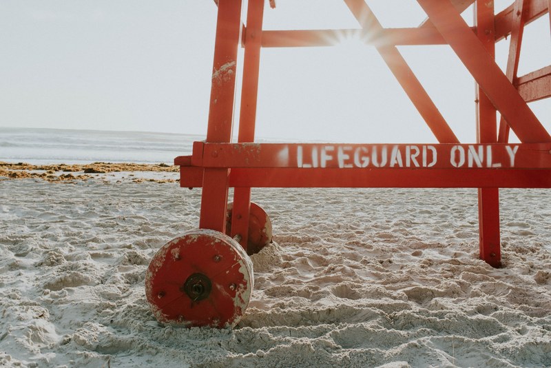 lower part of lifeguard tower with lifeguard only written on a sand daytona beach, lifeguard tower on a beach 4k