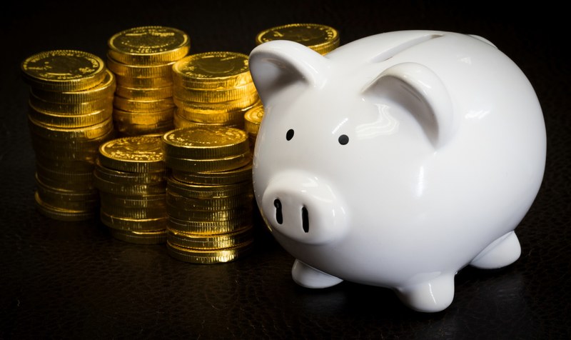 a white piggy bank next to a bunch of stacked gold coins, _piggy bank with chocolate coins 4k