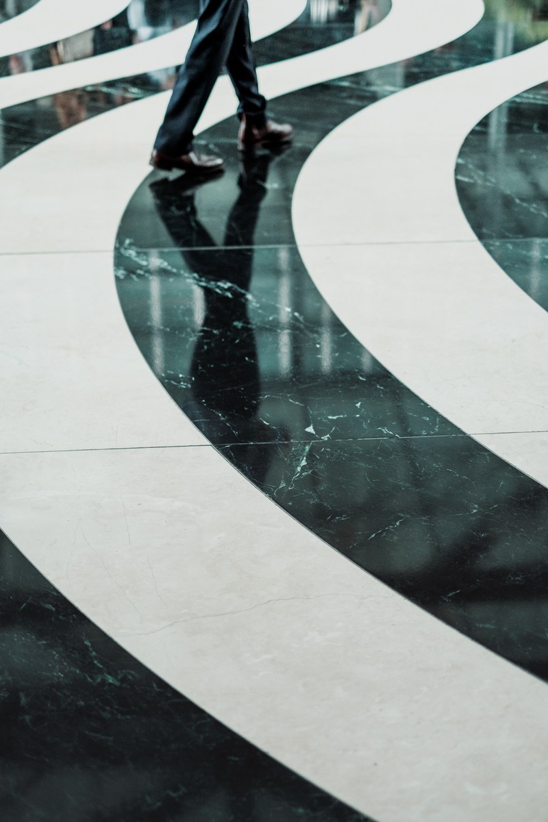 swirling black and white pattern on a marble floor, a wavy path 4k