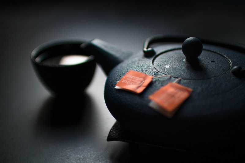 two tea bags in the black ceramic tea pot with a cup, teapot teacup laguna beach 4k