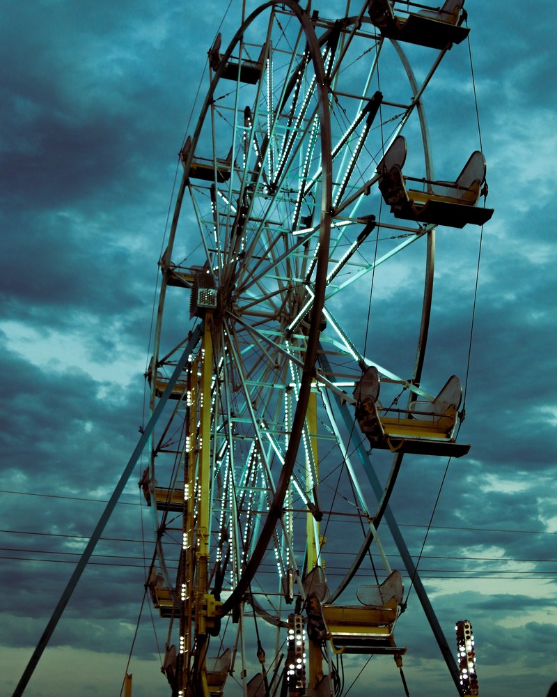 creepy abandoned ferris wheel at an empty circus on a cloudy night, a vintage ride 4k