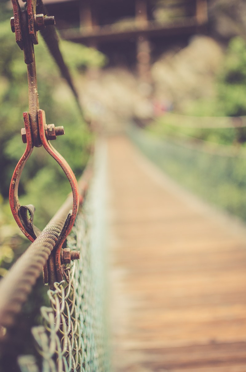 metal details on a suspension foot bridge, walking over a bridge 4k