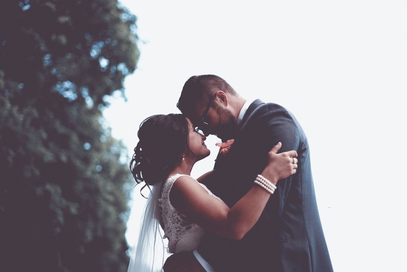 a couple holds their faces together smiling and embracing outdoors on their wedding day, forever happy beginning ending 4k