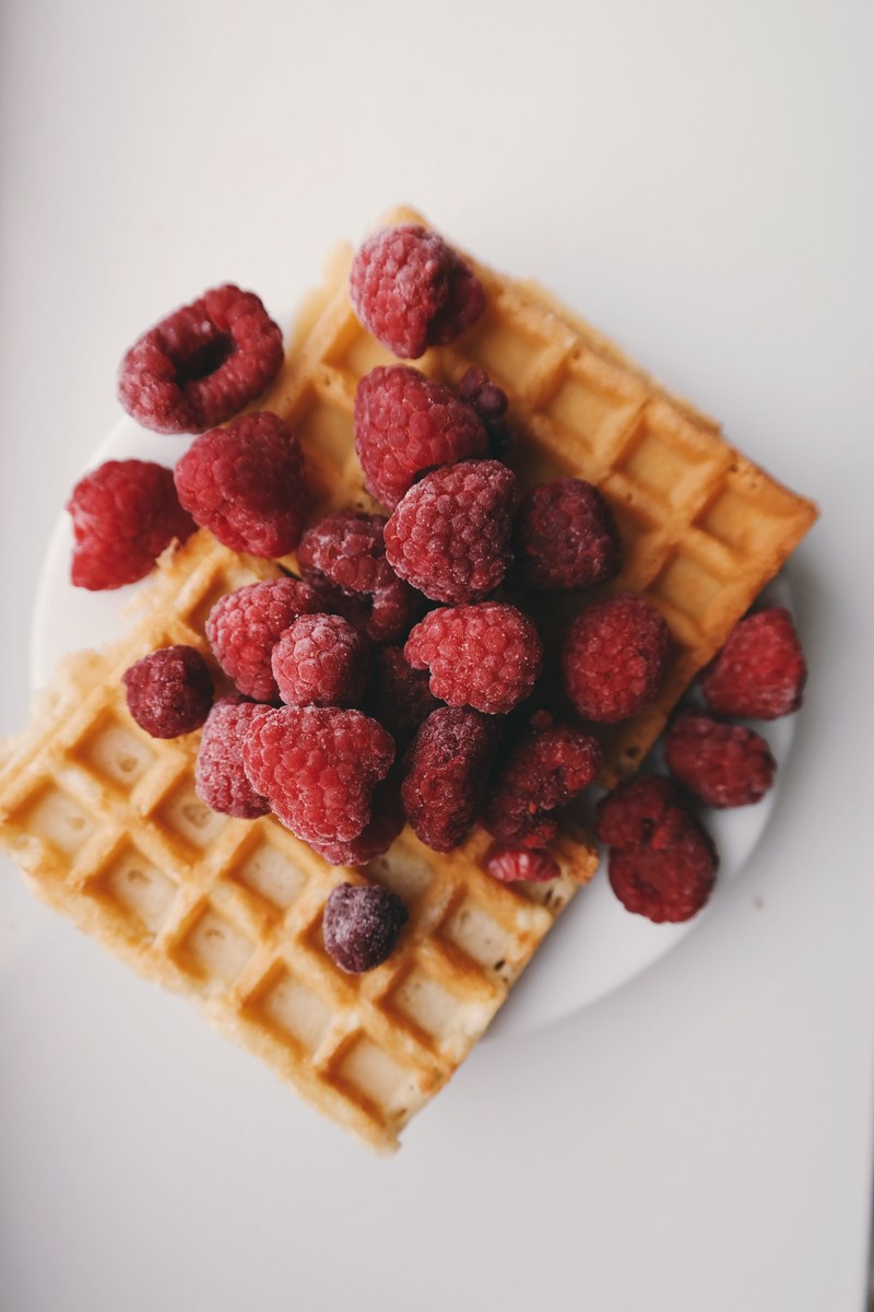 raspberries on top of a rectangle shaped waffle, _raspberry covered waffle 4k