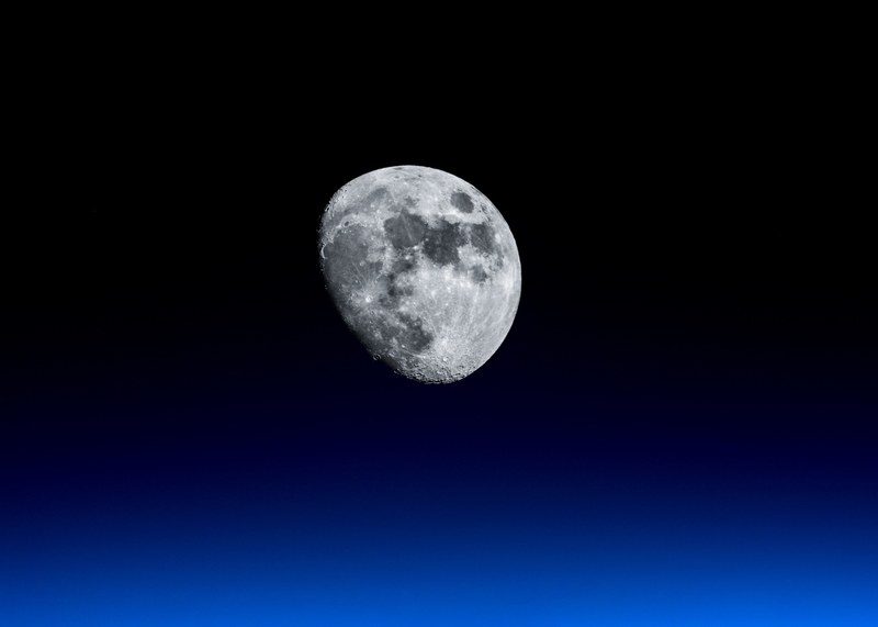 close up of the moon with lunar craters visible as seen from kaderabad housing society, beyond the horizon 4k