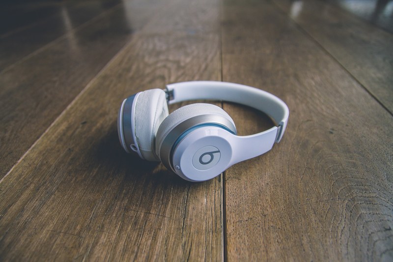 a pair of white wireless beats headphones on a wooden floor, cool beats bruh 4k