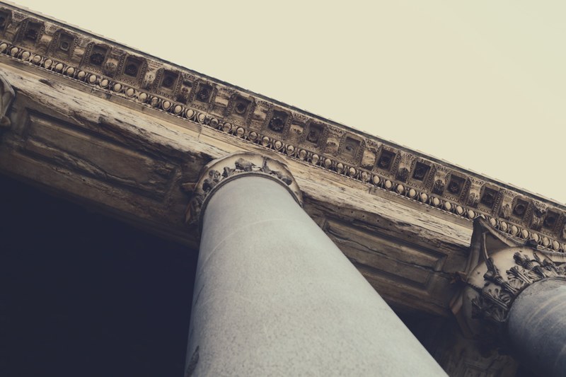 a shot looking up at a pillar with greek architectural features, greek architecture pillar 4k