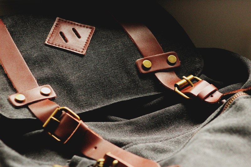 close up of a black backpack with leather straps, leather straps on a backpack 4k